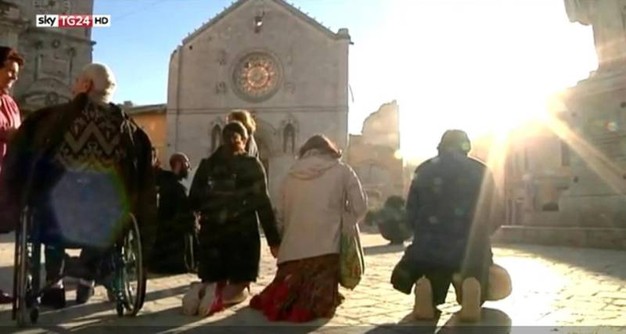 People praying in Norcia, Italy